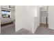 Hallway featuring a laundry closet and access to a well-lit bedroom with a sliding glass door at 9743 Mojave Mountain St, Las Vegas, NV 89166