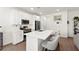 Modern kitchen featuring white cabinets, stainless steel appliances, quartz countertops, and an eat-in island at 9743 Mojave Mountain St, Las Vegas, NV 89166