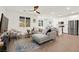 Open-concept living room with a gray sectional sofa and view of a modern kitchen at 9743 Mojave Mountain St, Las Vegas, NV 89166