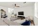 Spacious living room featuring modern decor, a comfortable sofa, and a large TV at 9743 Mojave Mountain St, Las Vegas, NV 89166