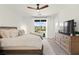Bright main bedroom featuring neutral decor, a dresser, and a sliding glass door leading to a balcony at 9743 Mojave Mountain St, Las Vegas, NV 89166