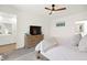 Bright main bedroom featuring wooden dresser, ceiling fan and ensuite bathroom at 9743 Mojave Mountain St, Las Vegas, NV 89166