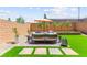 Inviting backyard patio area with built in seating, grass and privacy wall at 9743 Mojave Mountain St, Las Vegas, NV 89166