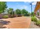 A spacious backyard features a basketball court surrounded by desert landscaping and shade trees at 9747 Cathedral Pines Ave, Las Vegas, NV 89149