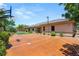 A spacious backyard features a basketball court with trampoline, desert landscaping and mature trees at 9747 Cathedral Pines Ave, Las Vegas, NV 89149