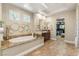 A bright bathroom with soaking tub, walk-in closet, and double sinks at 9747 Cathedral Pines Ave, Las Vegas, NV 89149
