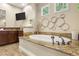 Bathroom featuring soaking tub with granite surround and TV on the wall at 9747 Cathedral Pines Ave, Las Vegas, NV 89149