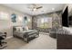 Bedroom featuring unique geometric wall design, ceiling fan, and carpet at 9747 Cathedral Pines Ave, Las Vegas, NV 89149