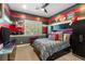 Bedroom featuring red, white, and grey walls, and a ceiling fan at 9747 Cathedral Pines Ave, Las Vegas, NV 89149