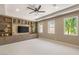 Large bonus room boasts built-in media center, neutral tones, and abundant natural light at 9747 Cathedral Pines Ave, Las Vegas, NV 89149