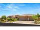 Beautiful single-story home with a tile roof, three car garage, and desert landscaping at 9747 Cathedral Pines Ave, Las Vegas, NV 89149