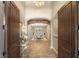 Grand foyer featuring stone floors, archways, and a view into the dining area at 9747 Cathedral Pines Ave, Las Vegas, NV 89149