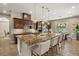Gourmet kitchen with a spacious granite island, pendant lighting, and views of the adjacent dining area at 9747 Cathedral Pines Ave, Las Vegas, NV 89149
