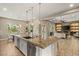 Open-concept kitchen with an island, stainless steel appliances, and easy access to the living area at 9747 Cathedral Pines Ave, Las Vegas, NV 89149