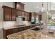 Modern kitchen with custom cabinets, stainless steel appliances, and a stylish backsplash at 9747 Cathedral Pines Ave, Las Vegas, NV 89149