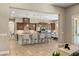 Open kitchen featuring a large island with seating, stainless steel appliances, and plenty of cabinet space at 9747 Cathedral Pines Ave, Las Vegas, NV 89149