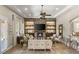 Inviting living room featuring a fireplace, built-in shelving, and a tray ceiling at 9747 Cathedral Pines Ave, Las Vegas, NV 89149