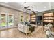 Cozy living room with a stone fireplace, built-in shelving, and plenty of natural light at 9747 Cathedral Pines Ave, Las Vegas, NV 89149