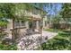 Relaxing backyard featuring a pergola-covered patio, artificial grass, and a well-maintained garden area at 9785 W Meranto Ave, Las Vegas, NV 89178