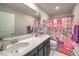 Well-lit bathroom featuring a double sink vanity and Disney themed decor at 9785 W Meranto Ave, Las Vegas, NV 89178