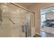 Bright shower with a glass enclosure and an open doorway showing the bedroom at 9785 W Meranto Ave, Las Vegas, NV 89178