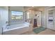 Bright bathroom featuring a soaking tub, a walk-in shower, and a window offering lovely neighborhood views at 9785 W Meranto Ave, Las Vegas, NV 89178