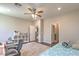 Functional bedroom with a ceiling fan, hardwood floors, and plenty of natural light at 9785 W Meranto Ave, Las Vegas, NV 89178