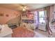 Charming ' bedroom with bunk beds, pink accents, and ample natural light at 9785 W Meranto Ave, Las Vegas, NV 89178