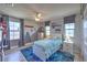 Bright bedroom with large windows, ceiling fan, and decorative blue accents at 9785 W Meranto Ave, Las Vegas, NV 89178
