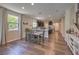 Bright dining area with wood flooring and a kitchen island at 9785 W Meranto Ave, Las Vegas, NV 89178