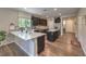 Spacious kitchen with stone countertops, stainless appliances, kitchen island and dark wood cabinets at 9785 W Meranto Ave, Las Vegas, NV 89178