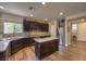 Open-concept kitchen with stainless appliances, gas cooktop, eat-in dining, and stone countertops at 9785 W Meranto Ave, Las Vegas, NV 89178