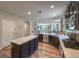 Open kitchen featuring gas cooktop, island with stone countertops, stainless appliances, and dark wood cabinets at 9785 W Meranto Ave, Las Vegas, NV 89178