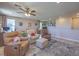 Cozy living room with comfortable seating, ceiling fan, and a stylish area rug at 9785 W Meranto Ave, Las Vegas, NV 89178
