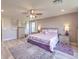 Cozy main bedroom showcasing a king bed, ceiling fan, neutral tones and hardwood floors at 9785 W Meranto Ave, Las Vegas, NV 89178