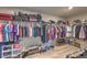 Spacious walk-in closet with ample storage space and a variety of clothing and accessories neatly arranged at 9785 W Meranto Ave, Las Vegas, NV 89178