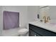Cozy powder bathroom with a modern sink, toilet, and a purple towel at 9844 Kings Glen St, Las Vegas, NV 89141