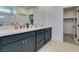 Modern bathroom with double sinks, gray cabinets, quartz counters, and walk-in closet access at 9844 Kings Glen St, Las Vegas, NV 89141