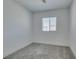 Clean bedroom with a neutral carpet, white walls, and bright window at 9844 Kings Glen St, Las Vegas, NV 89141