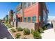 Colorful townhome exterior featuring modern design, landscaping, and a private gated entrance at 9844 Kings Glen St, Las Vegas, NV 89141