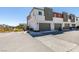 New townhome with two-car garage, modern design, and landscaping at 9844 Kings Glen St, Las Vegas, NV 89141
