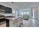 Bright, open-concept kitchen with a granite island and seating, flowing into the living area at 9844 Kings Glen St, Las Vegas, NV 89141