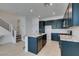Modern kitchen with dark cabinets, granite countertops, stainless steel appliances, and a central island at 9844 Kings Glen St, Las Vegas, NV 89141