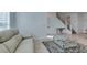 Open-concept living room features stair access, mirrored console, and view into the home at 9844 Kings Glen St, Las Vegas, NV 89141