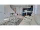 Bright living room with staircase and kitchen access features modern furniture and fixtures at 9844 Kings Glen St, Las Vegas, NV 89141