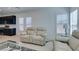 View of the living room showcasing sleek furniture and a glimpse of the open kitchen layout at 9844 Kings Glen St, Las Vegas, NV 89141
