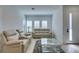 Bright living room featuring comfortable seating, a mirrored coffee table, and lots of natural light at 9844 Kings Glen St, Las Vegas, NV 89141