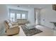 Bright living room features neutral paint, plush seating, and modern decor, bathed in natural light at 9844 Kings Glen St, Las Vegas, NV 89141