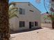 The backyard featuring a desert landscape, brick patio, and stucco privacy wall at 1018 Sun Poppy Ave, Las Vegas, NV 89123