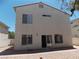 A view of the backyard with a stucco wall, patio, and desert landscaping of the home at 1018 Sun Poppy Ave, Las Vegas, NV 89123